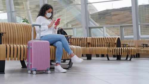 Girl Traveler with Phone in Station Waiting Area