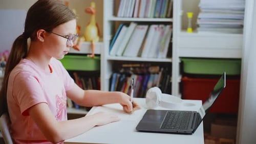 Girl Studying at Desk With Laptop and Books