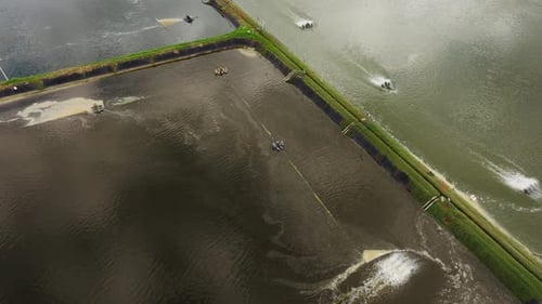 Aerial View of Shrimp Farm Aerators Operating in Rectangular Ponds Thailand