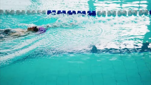A Tranquil Swimming Pool Scene with Reflections and Vibrant Blue Water Evoking Serenity and Sport