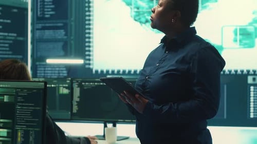 Governmental Hackers Working on Computer Network in High Tech Office