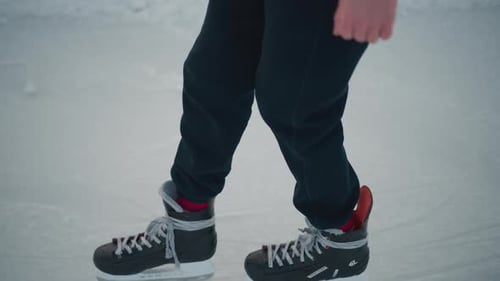 Leg View Skater in Black Trousers Skating Skillfully on Ice Rink