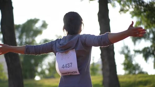 Woman Stretching After Marathon in the Park