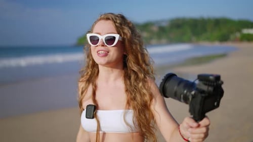 Travel Influencer Films with Pro Camera on Beach Content Creator Engages Audience Shares Tips