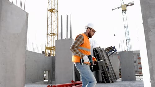 Positive dance of builders in helmet. Construction engineer in builder uniform dancing on his work