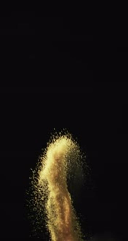 Vertical video of white sand grains thrown in air and copy space on black background