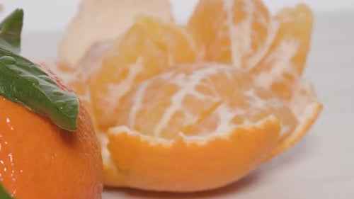 Gros plan des segments d'une mandarine pelée, tournant en rond pour révéler une frue bien mûre