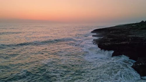 Pastel Sunrise Splashing Ocean Aerial View Surfs Washing Rocky Coast Seashore