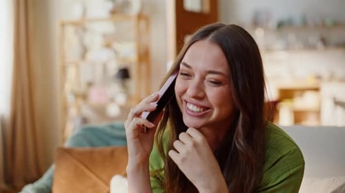 Excited woman smiles during a phone call