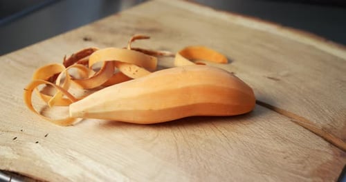 Peeled Sweet Potato on a Wooden Cutting Board