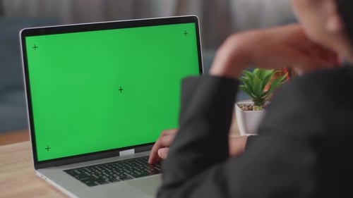 Close Up Of Asian Businesswoman Typing On Green Screen Laptop Computer Then Thinking While Working