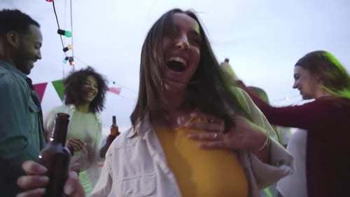 Young Adults Dancing and Celebrating at Rooftop Party