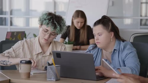 Two Diverse Female Colleagues Coworking in Office