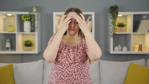 Woman Rubbing Temples To Relieve Headache Pain