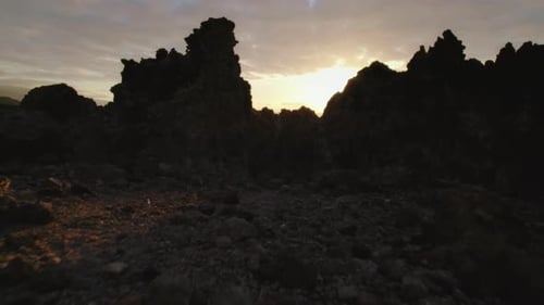 Drone flight over coastal cliffs with waves crashing against rocky shores. Towering volcanic steep c