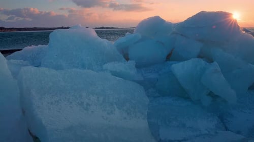 Winter Landscape of Broken Crystalline Ice Layers with Soft Sunset Tones