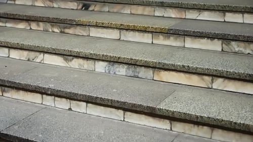 Closeup View of Weathered Stone Staircase with Textured Granite Treads and Marble Risers Showcasing