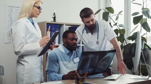 Multicultural Group of Medical Students Discussing About Sickness Doctor s Office with Medical