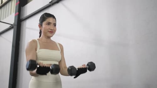 Pretty woman is exercising at a fitness center.