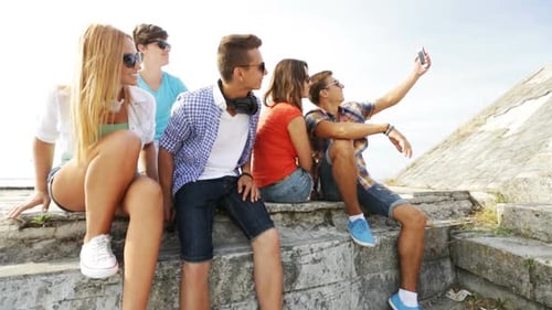 Summer Vacation, Friendship, Street Life, Technology And People Concept - Group Of Smiling Teenag...