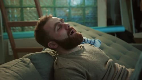 Close Up Face Young Poor Couple Lying on Sofa Feel Shock Stress Unhealthy Alcoholic Creepy Home