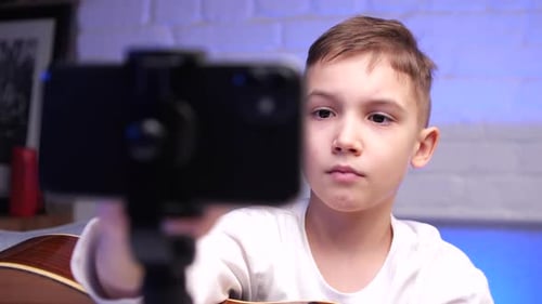 Young Boy with Smartphone on Tripod