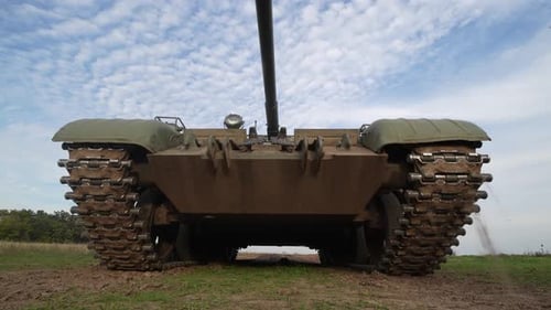 Tank Vehicle on Field Under Cloudy Skies