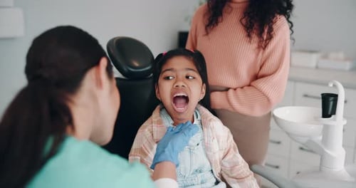 Child Examined by Dentist in Brightly Lit Office