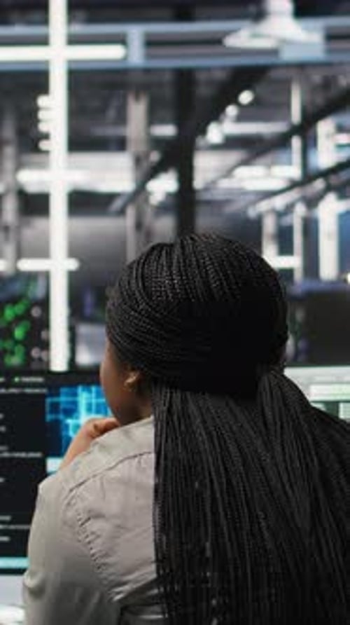 Vertical Video Data Center Manager Supervising Worker Deploying AI Solutions