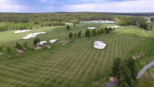 An Aerial View Highlights a Stunning Golf Course Embraced By Lush Nature Creating Beauty