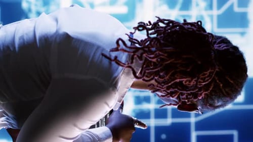 Programmer Focused on Code in Futuristic Environment