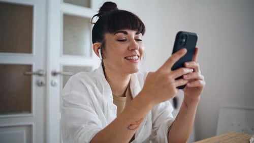 Smiling Artist Holding Smartphone Home Close Up Earphones Woman Listening Music