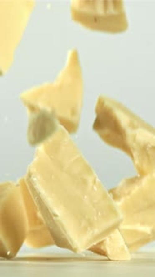Pieces of White Chocolate Fall on the Table Filmed on a Highspeed Camera at 1000 Fps
