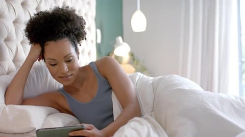 Woman Relaxing in Bed with Smartphone