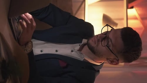 Young Adult Typing on a Laptop at Work