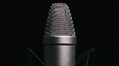 The Studio Condenser Microphone Rotates on a Black Background CloseUp