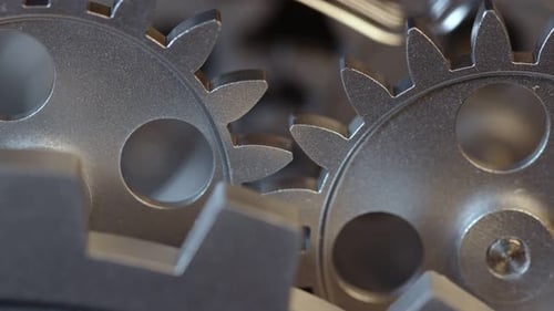 Rotating Silver Gears in a Meshing Mechanism