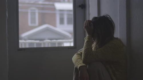 Sad Woman Sitting on Floor by Window