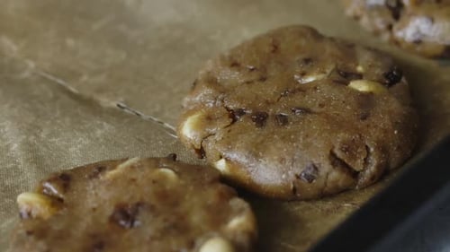Cookies With Peanuts And Chocolate Chips. Lies On A Baking Sheet Before Baking.