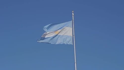 Flag Waving Against a Clear Blue Sky