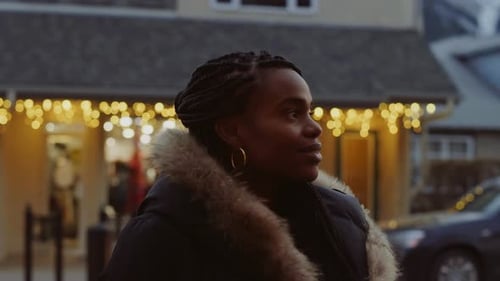 Festive Woman Smiling on Winter Street