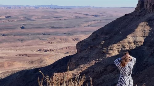Young Woman Standing at Edge of Fish River Canyon in Namibia