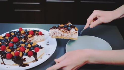 Serving Delicious Homemade Cheesecake with Berries and Almonds