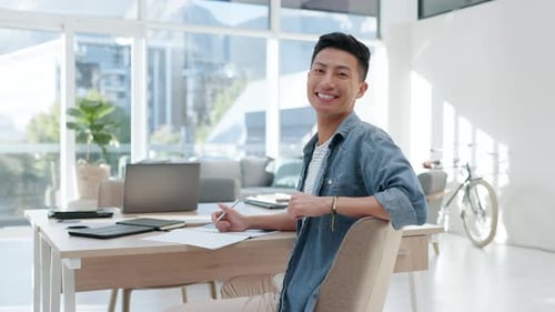Face, happy man and creative writer in office, startup company or workplace on table