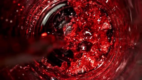 Dark Red Liquid Swirls in Glass Container