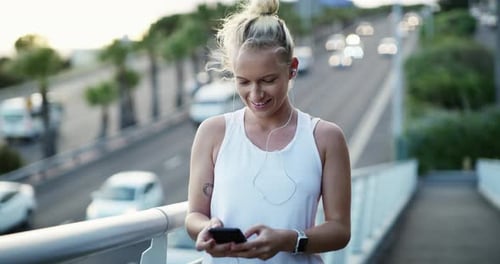 Earphones, fitness and woman with cellphone in city preparing for cardio race