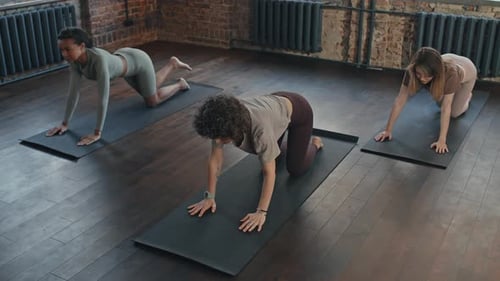 Group Of Three Women Practicing Yoga