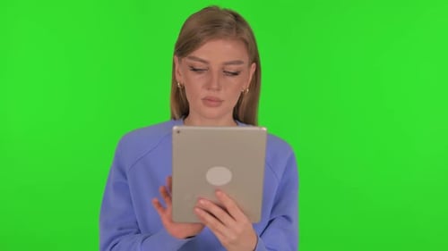 Woman Using Digital Tablet on Green Background