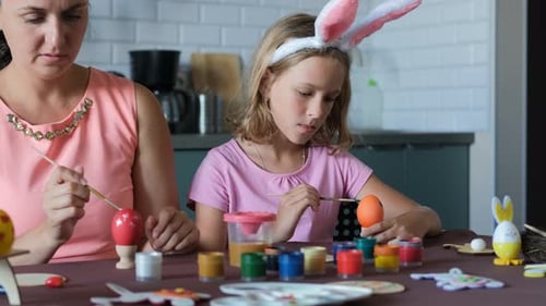 Mother and Daughter Painting Easter Eggs Together