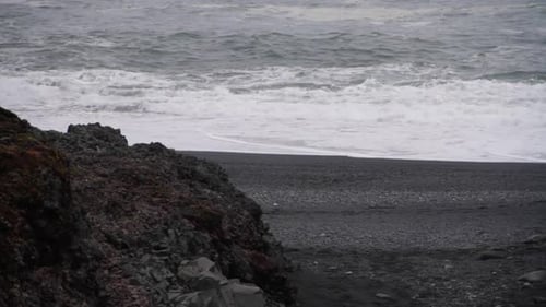 Waves Splash against Shore on Icelandic Black Sand Beach